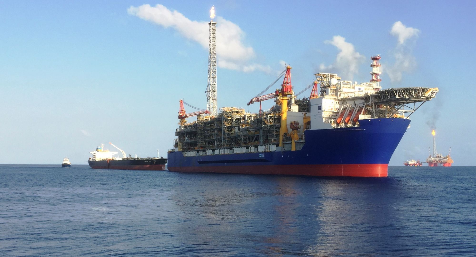 Inpex's Ichthys Venturer FPSO loading condensate with the Ichthys Explorer central processing platform in the background.